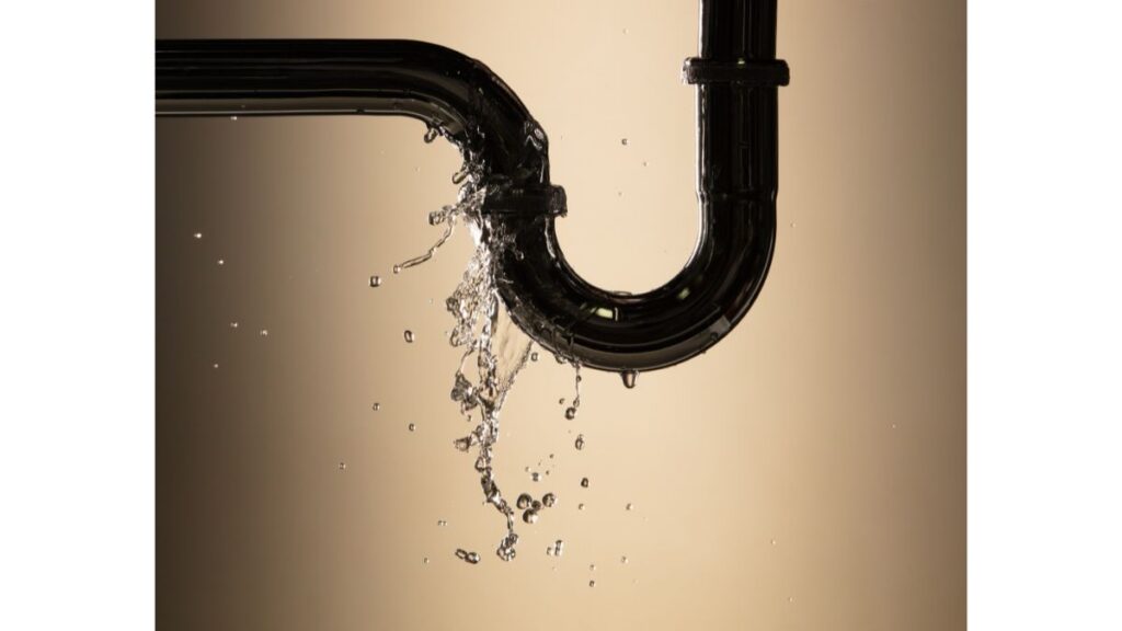 Leaking plumbing pipe with water dripping before an emergency repair
